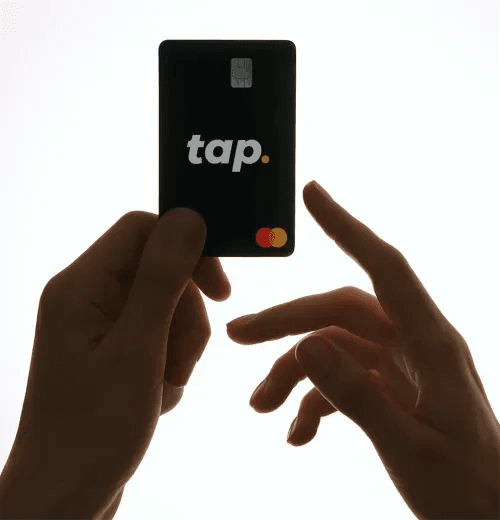 Hands holding the black Tap Mastercard